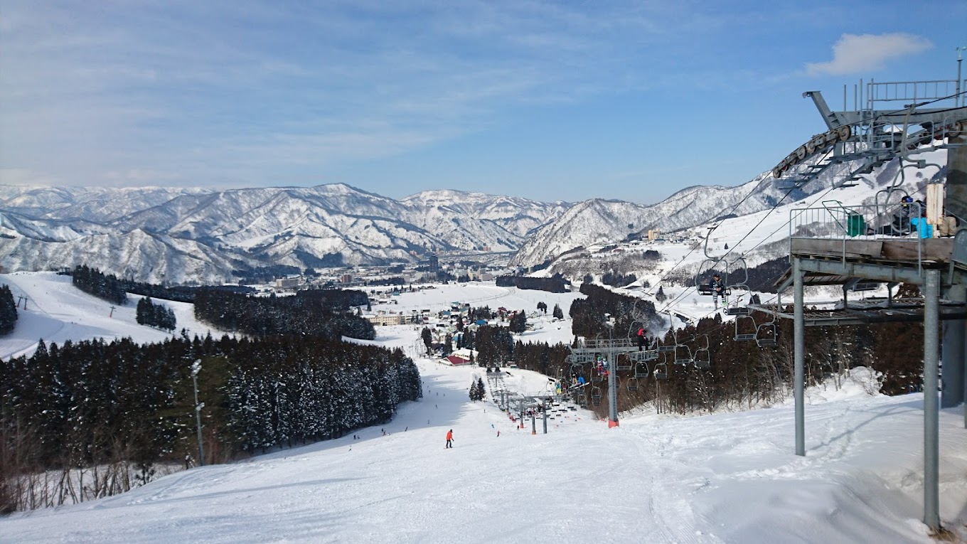 Yuzawa Park in Japan - a ski lift going down a snowy slope.