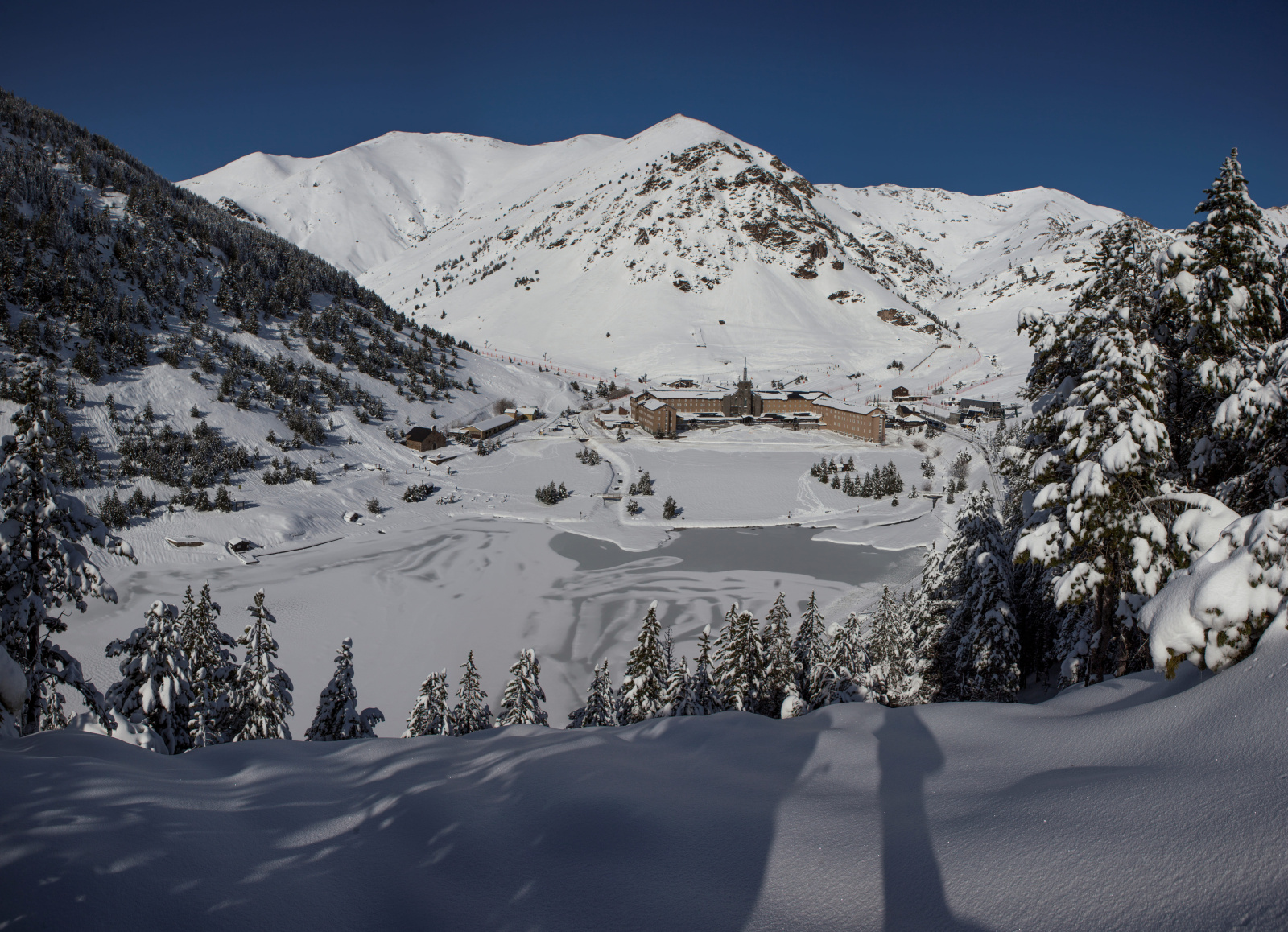 Vall de Núria in Spain - a person on a snowboard in the snow.