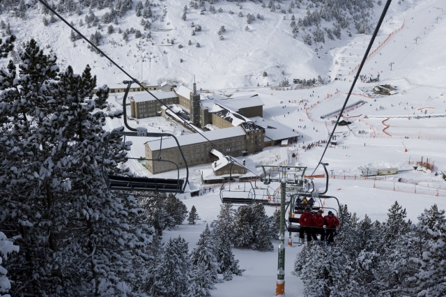 Vall de Núria in Spain - a ski lift going up a snowy mountain.