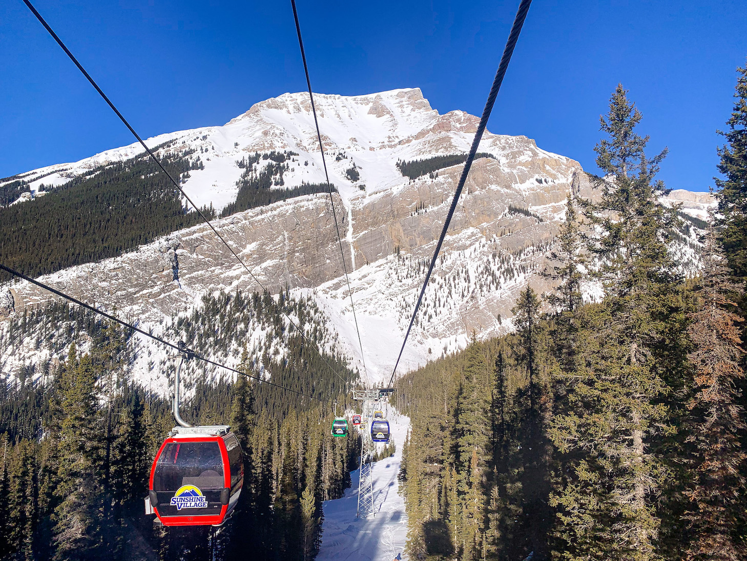 Banff Sunshine in Canada - a ski lift going up a snowy mountain.