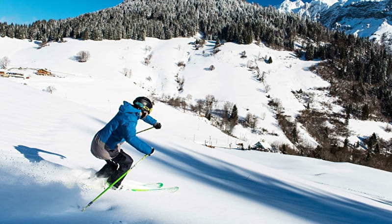 La Forclaz in Switzerland - a man riding skis down a snow covered slope.