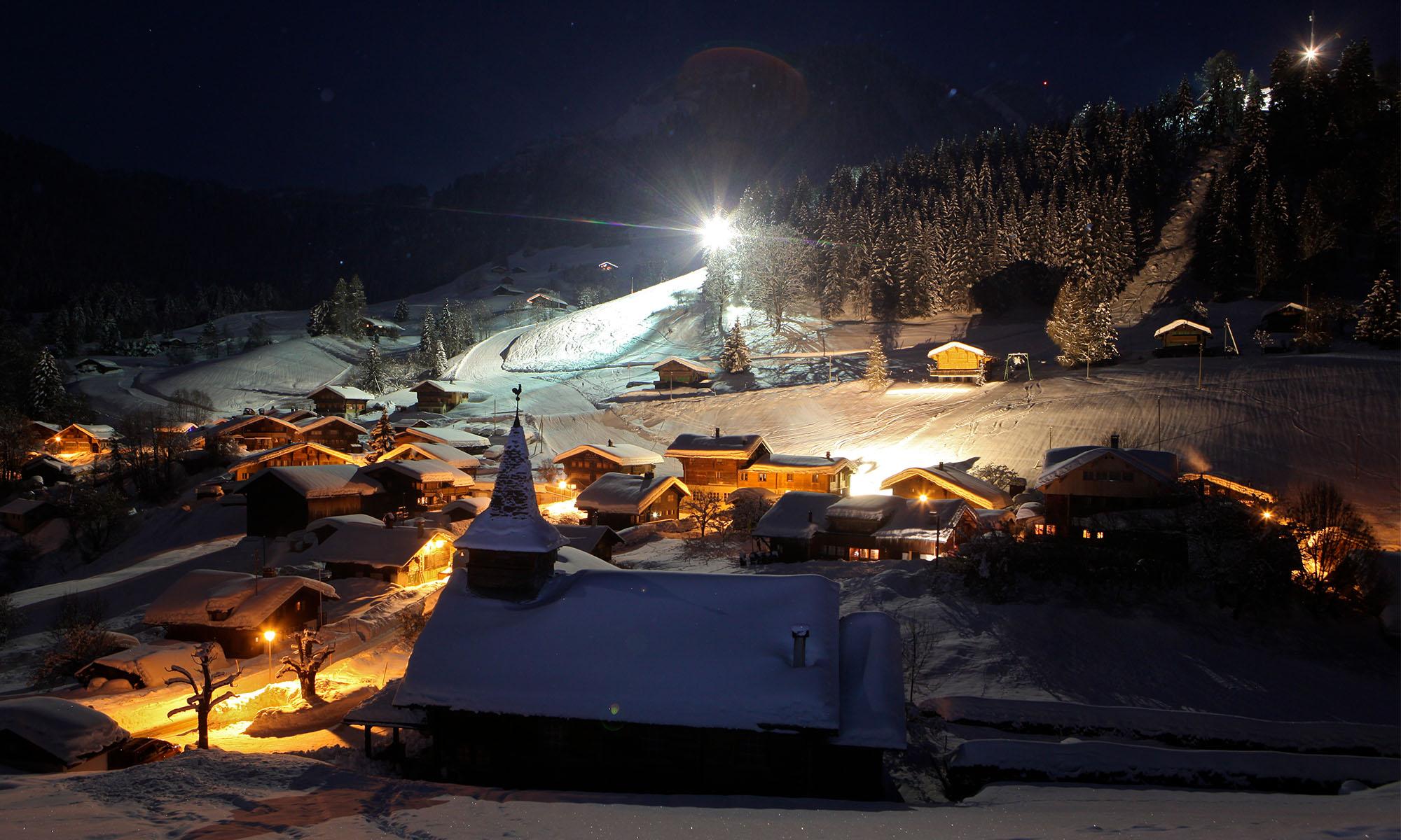 La Forclaz in Switzerland - a snowy village at night in the swiss alps.