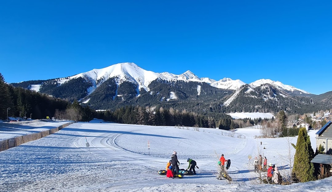 Hohentauern in Austria - a group of people standing on top of a snow covered slope.