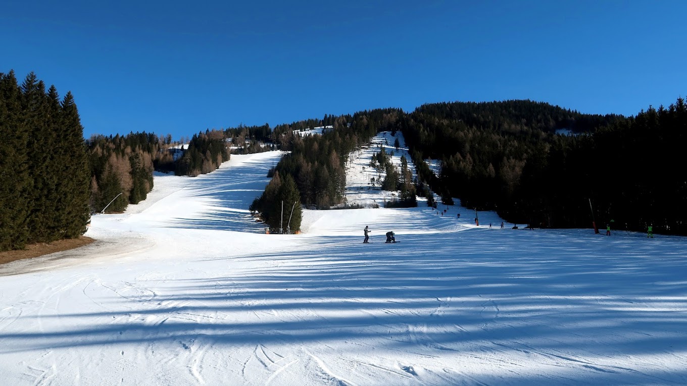Hohentauern in Austria - a ski slope with people skiing down it.