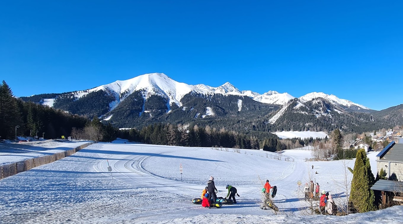 Hohentauern in Austria - a group of people skiing down a snow covered slope.