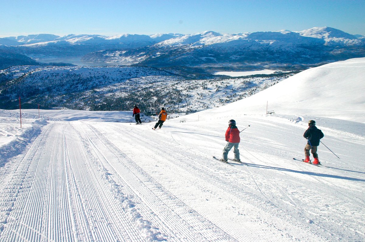 Stryn Vinterski in Norway - a group of people skiing down a snow covered mountain.