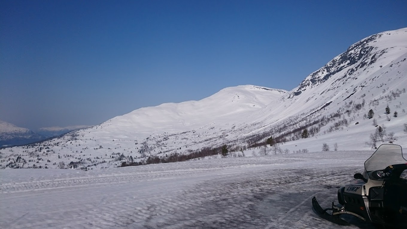 Stryn Vinterski in Norway - a snowmobile on a snowy road in the mountains.