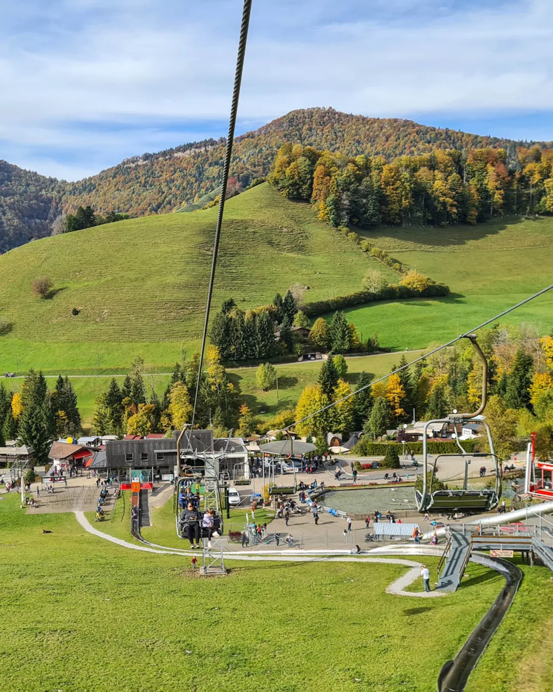 Atzmännig in Switzerland - a ski lift going up a hill in the fall.