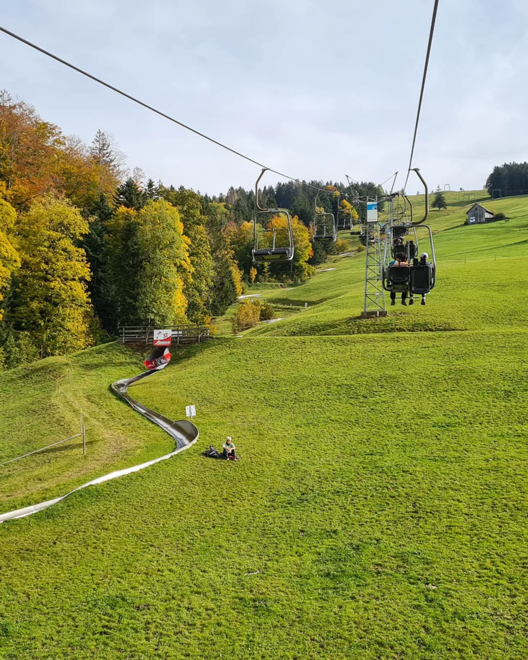 Atzmännig in Switzerland - a ski lift going up a hill in the fall.