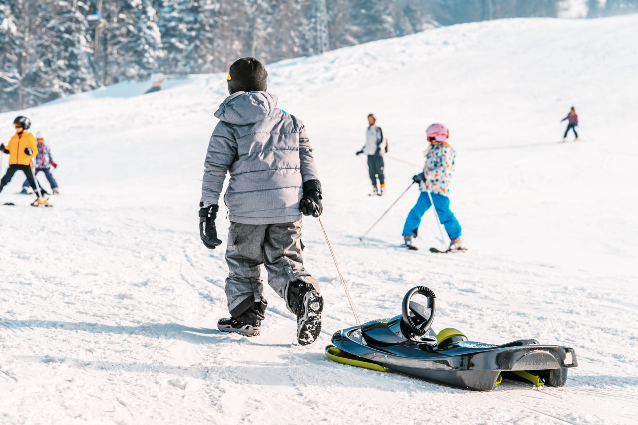 Atzmännig in Switzerland - a group of people skiing down a hill.