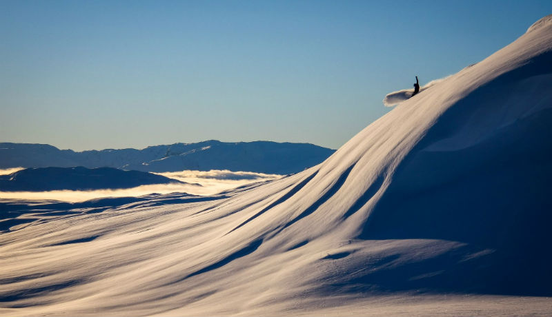 Sogndal Skisenter - Hodlekve in Norway - a person standing on top of a snowy hill.