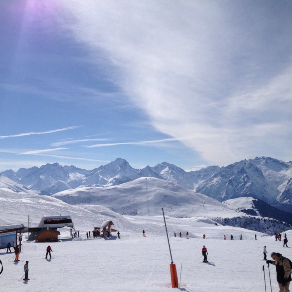 Les Plans d'Hotonnes in France - a group of people skiing down a snow covered mountain.