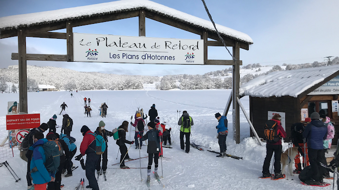 Les Plans d'Hotonnes in France - a group of people standing in the snow.