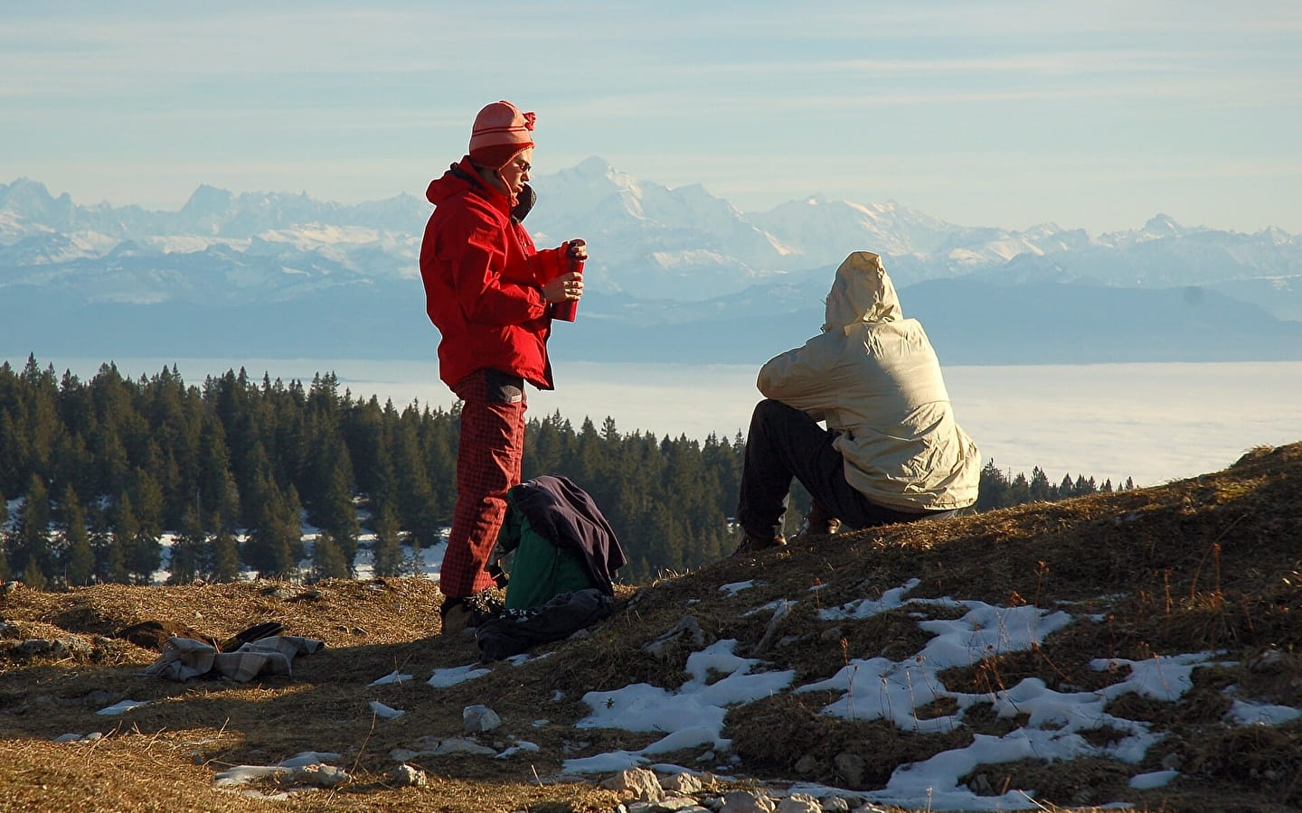 Le Noirmont in France - two people sitting on top of a mountain.
