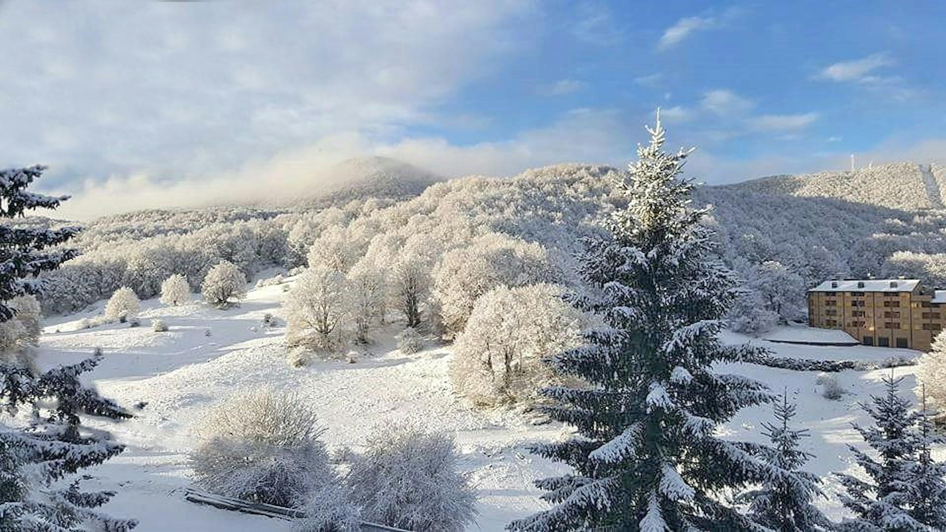Marsia – Tagliacozzo in Italy - a snow covered mountain with trees in the fore.