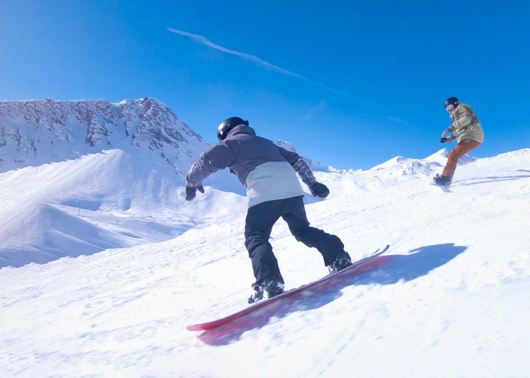 Marsia – Tagliacozzo in Italy - two snowboarders going down a snowy slope.
