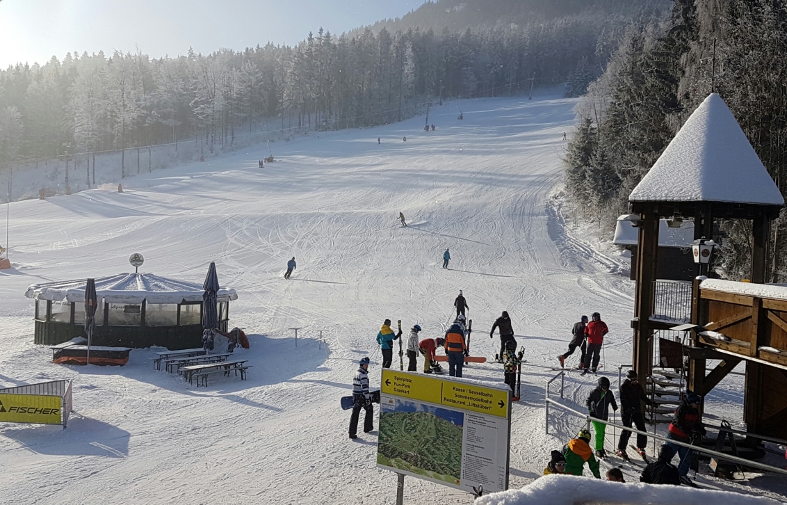 Hohenbogenbahn in Germany - a group of people skiing down a snowy hill.