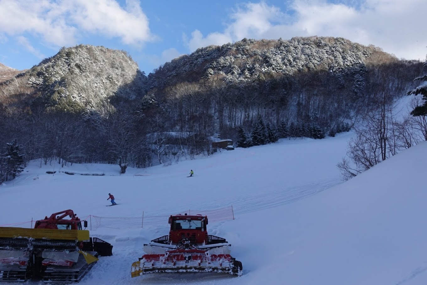 Giant Ski area in Japan - two snowmobiles are parked on the side of a mountain.