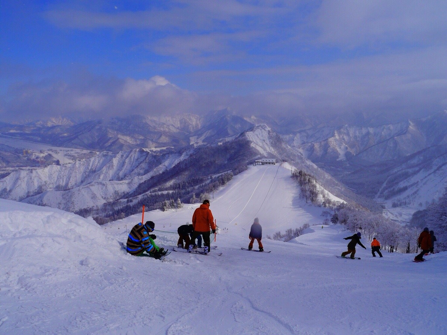 Mineyama Kogen in Japan - a group of people skiing down a mountain.