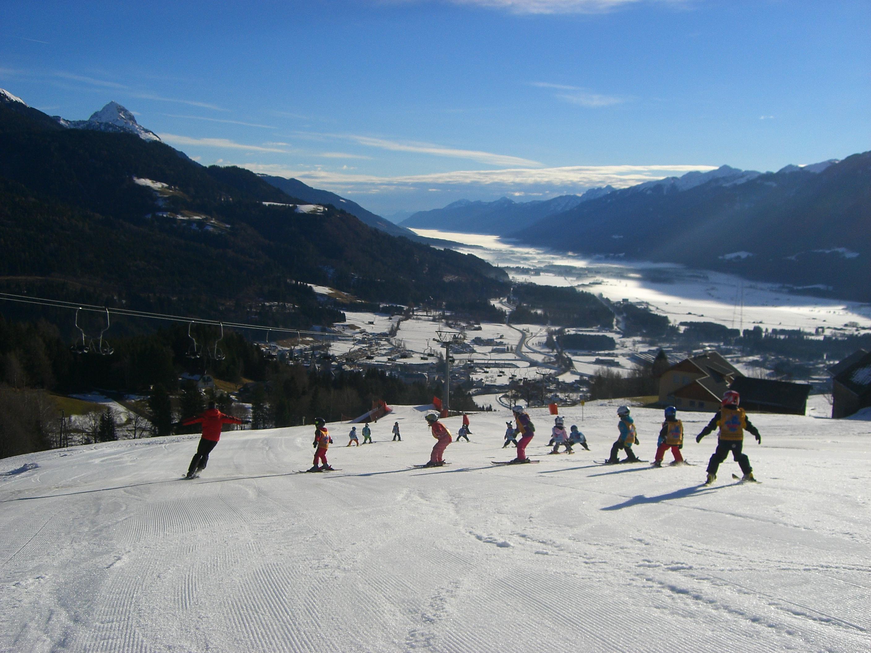 Kötschach-Mauthen in Austria - a group of people skiing down a mountain.