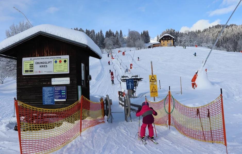 Kötschach-Mauthen in Austria: people skiing down the slope at a ski resort.