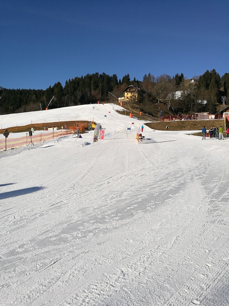 Kötschach-Mauthen in Austria - a group of people skiing down a snow covered slope.