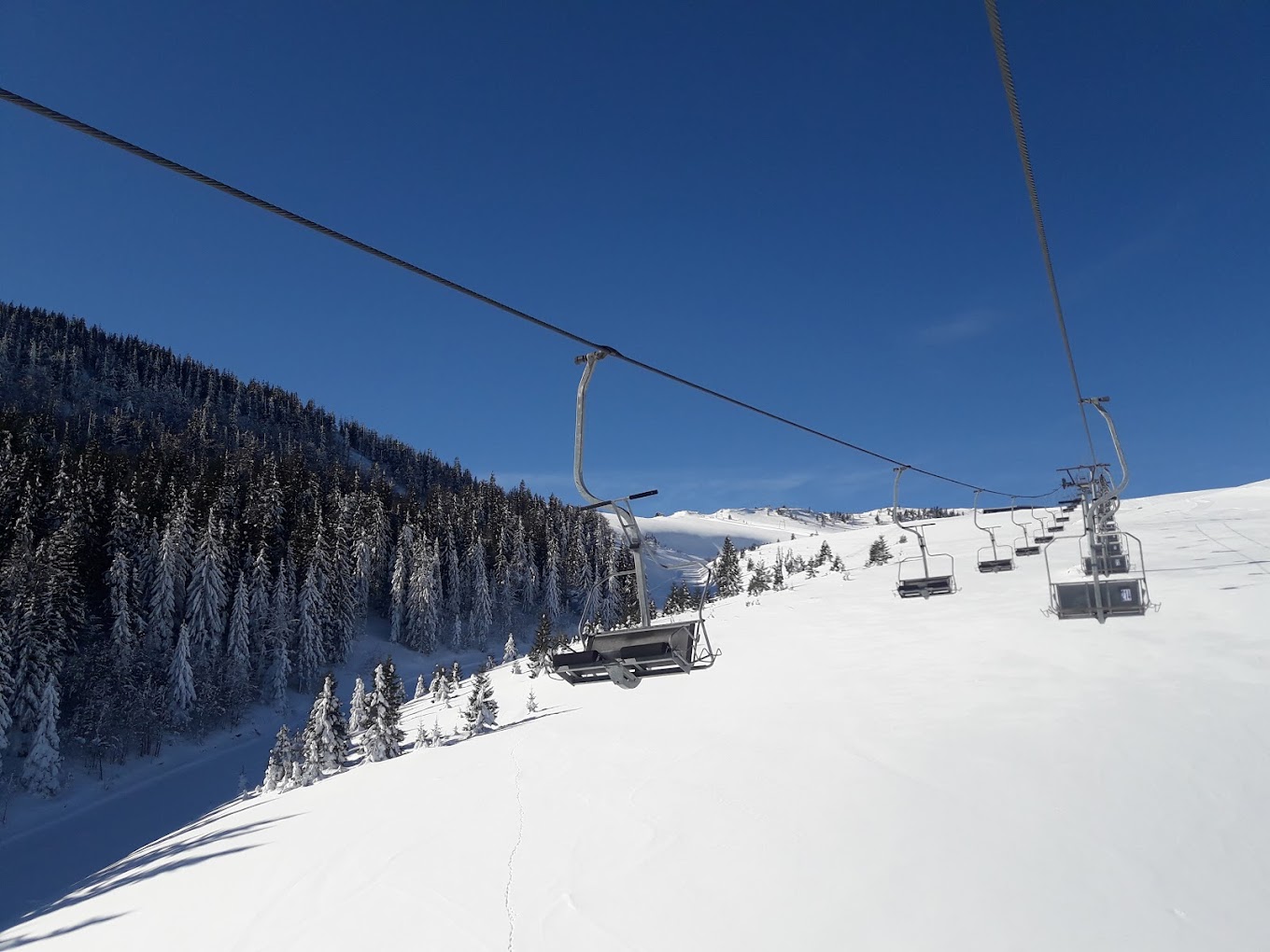 Radusa in Bosnia and Herzegovina - a ski lift going up a snowy slope.