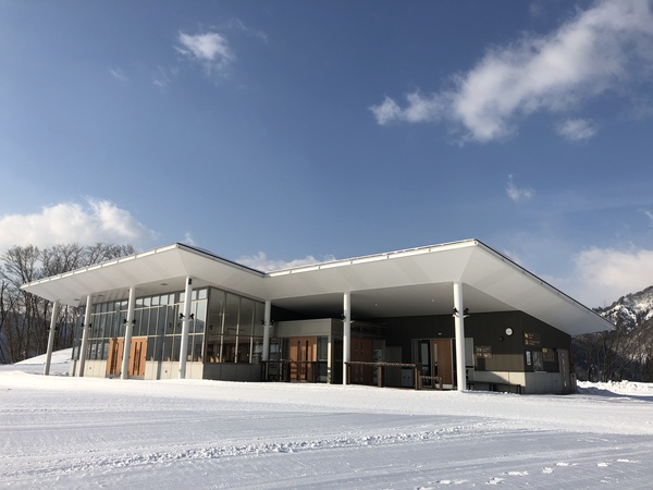 Asahi Shizen in Japan: a large white building sitting on top of snow covered ground.