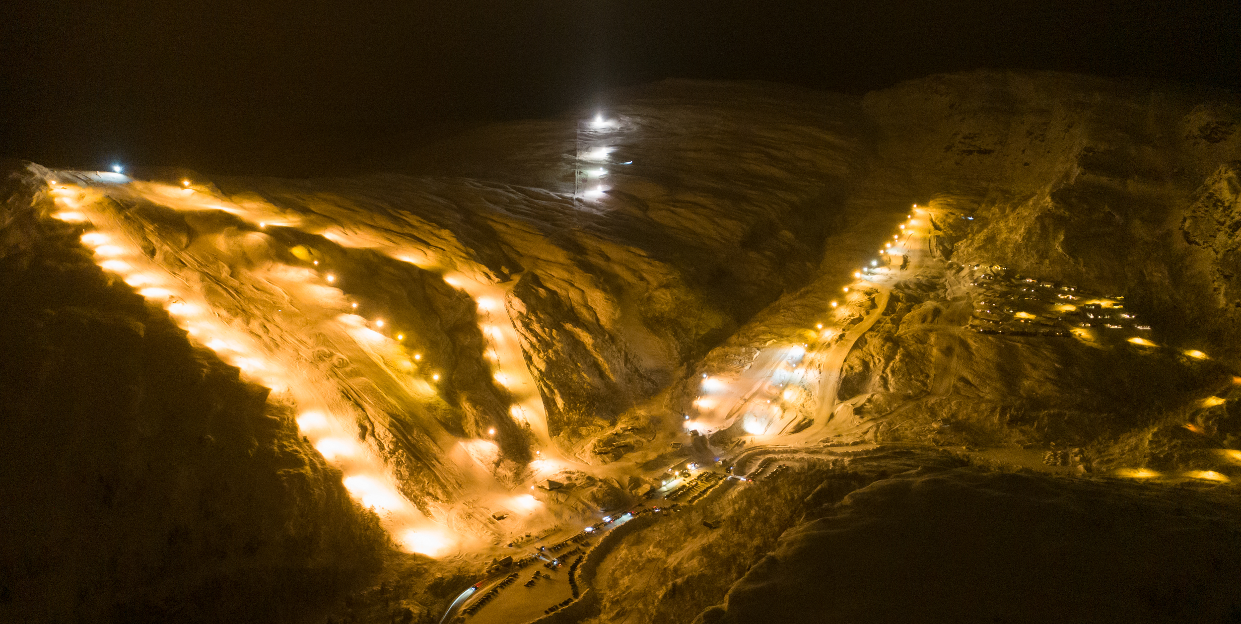 Eikedalen in Norway - a night time view of a mountain with lights.