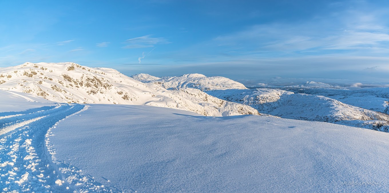 Eikedalen in Norway - a snow covered mountain with mountains in the background.