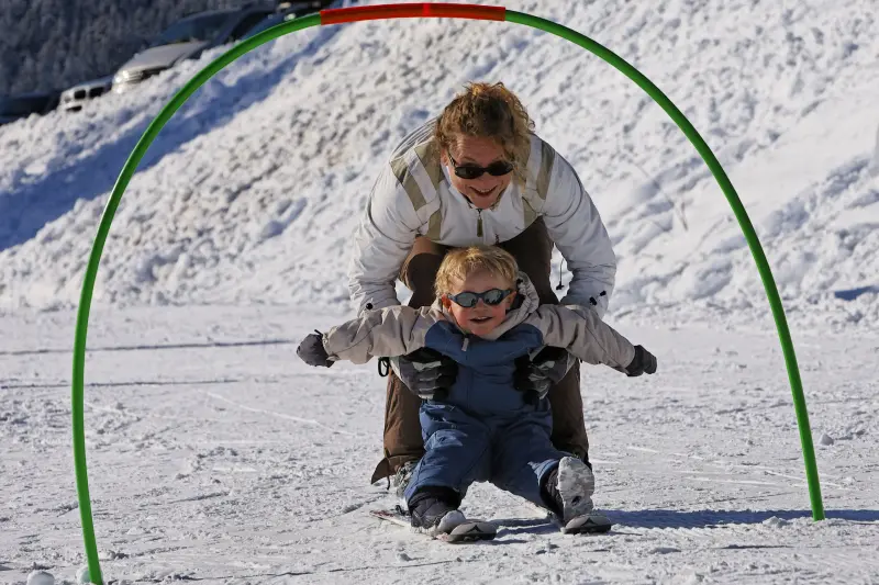 Cordon in France - a woman and child playing in the snow.