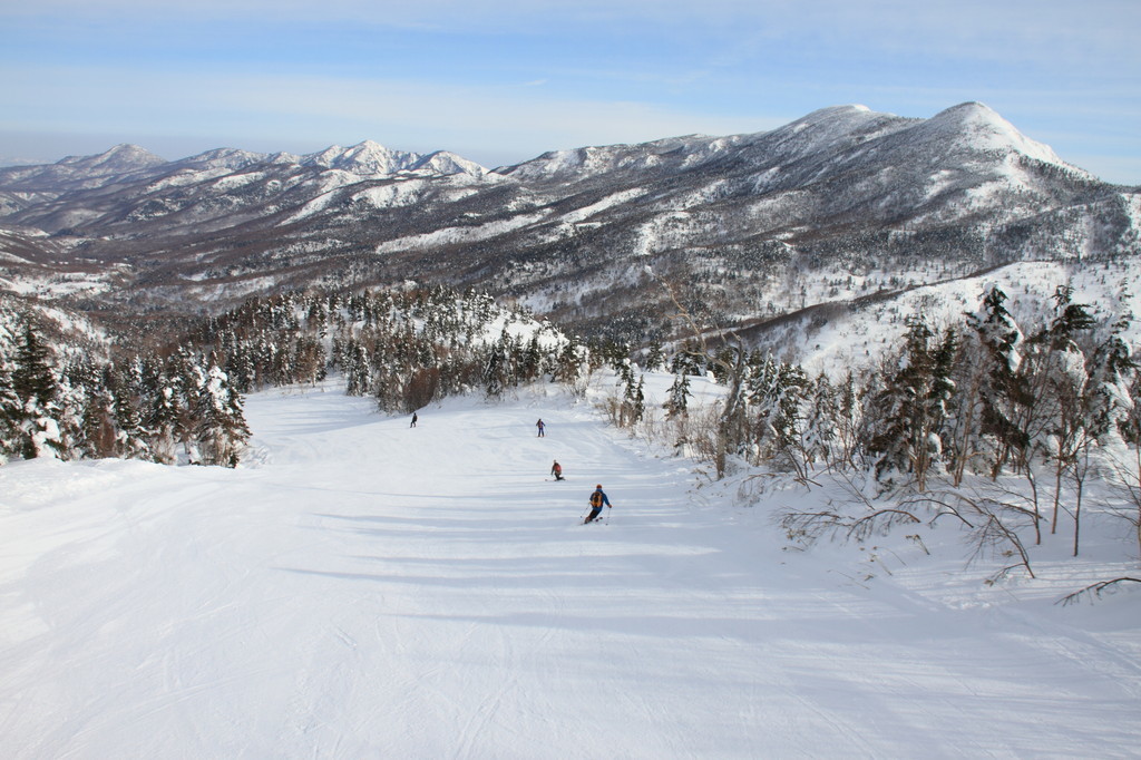 Shiga Kogen Terakoya in Japan - a person riding a snowboard down a hill.