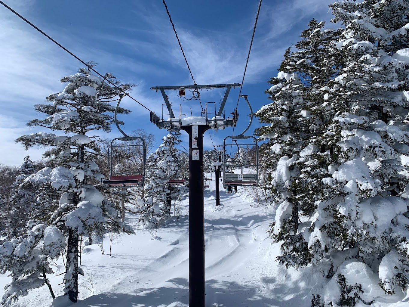 Shiga Kogen Terakoya in Japan - a ski lift going up a snowy hill.