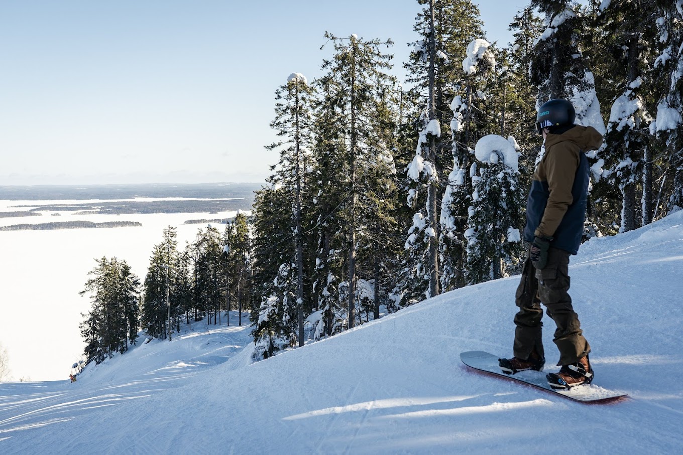 Koli Ski - Ukko-Kolin rinteet in Finland - a person on a snowboard in the snow.