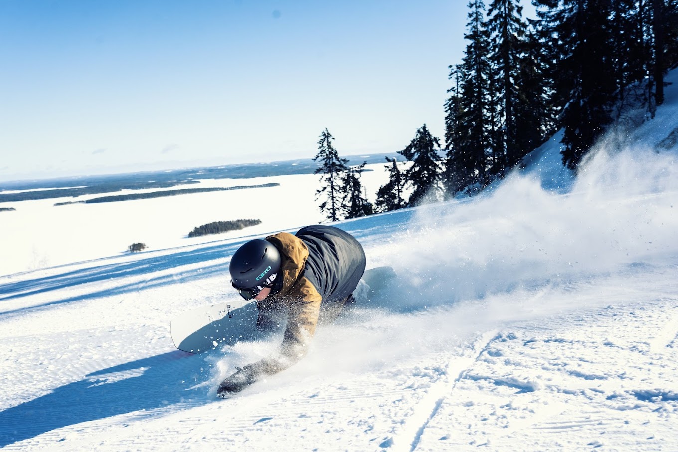 Koli Ski - Ukko-Kolin rinteet in Finland - a person on a snowboard in the snow.