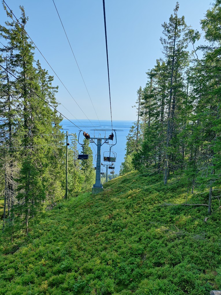 Koli Ski - Ukko-Kolin rinteet in Finland - a ski lift going up the mountain to the ocean.