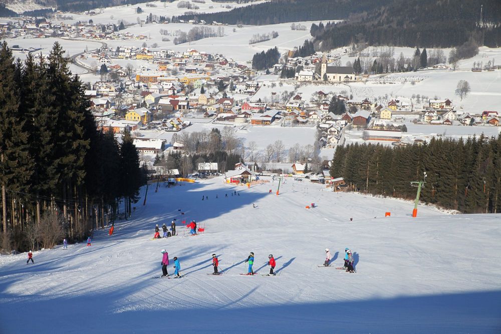 Schwabenbergarena Turnauer Schilift in Austria - a group of people skiing down a hill.