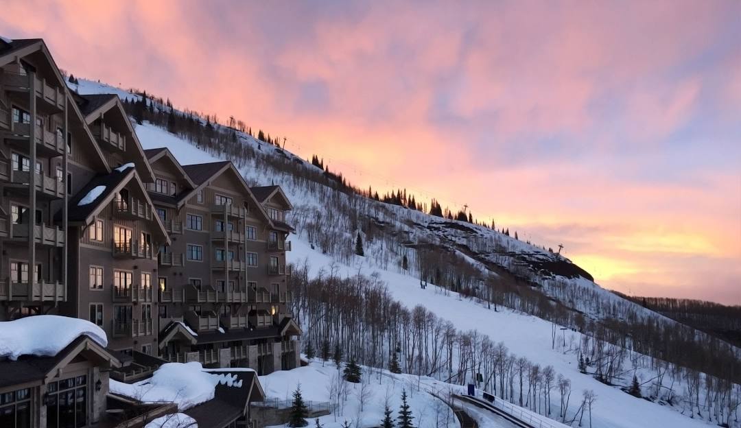 Stowe in USA: a ski resort in the mountains at sunset.