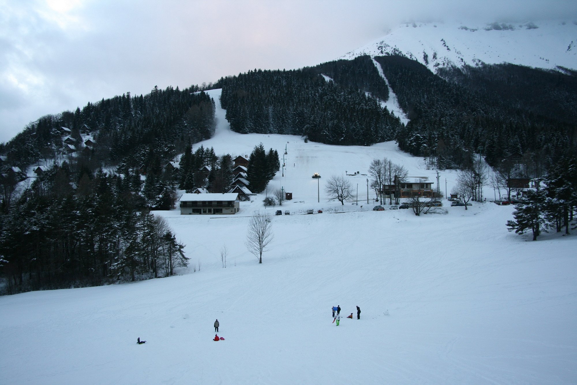 Col de l'Arzelier in France - a group of people skiing down a snowy hill.
