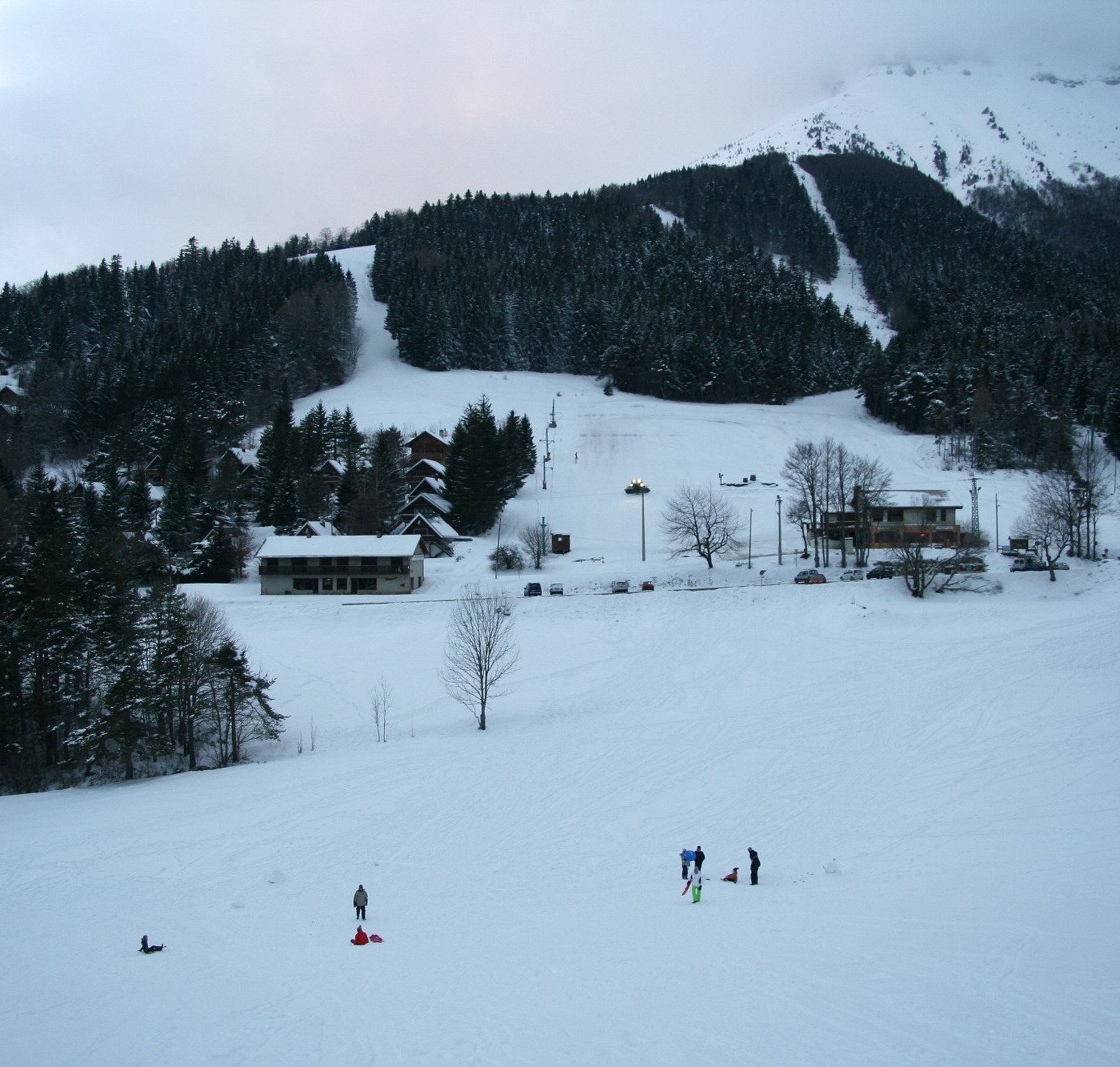 Col de l'Arzelier in France - a group of people skiing down a snowy hill.