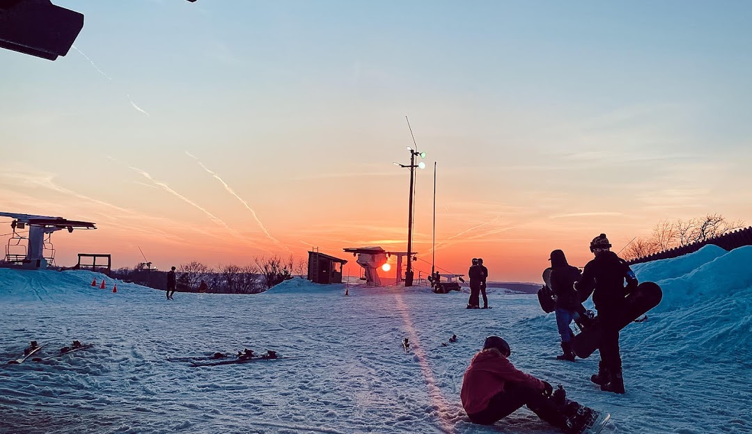Font d'Urle in France - a group of people sitting on top of snow covered ground.