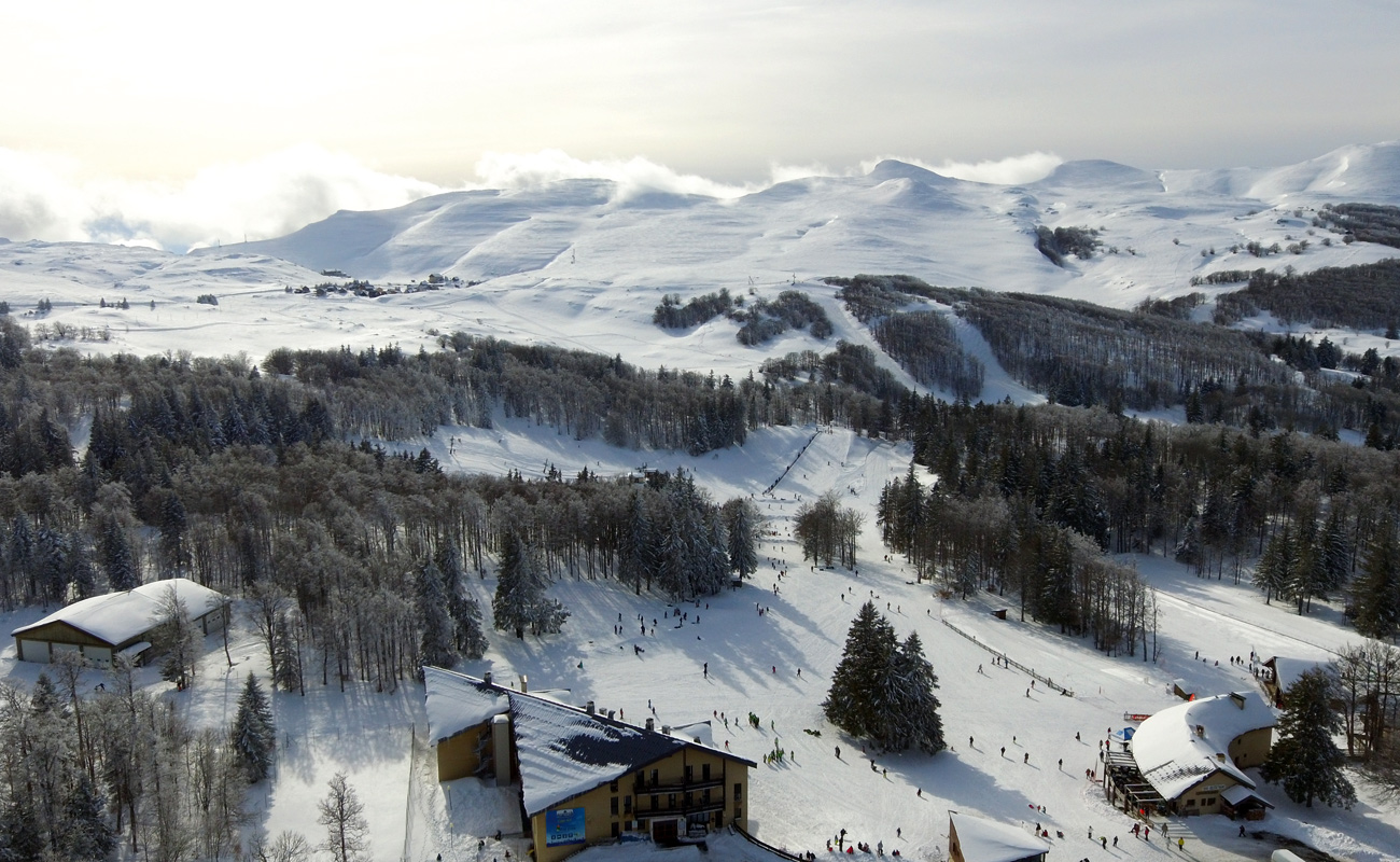 Font d'Urle in France - a group of people skiing down a snowy slope.