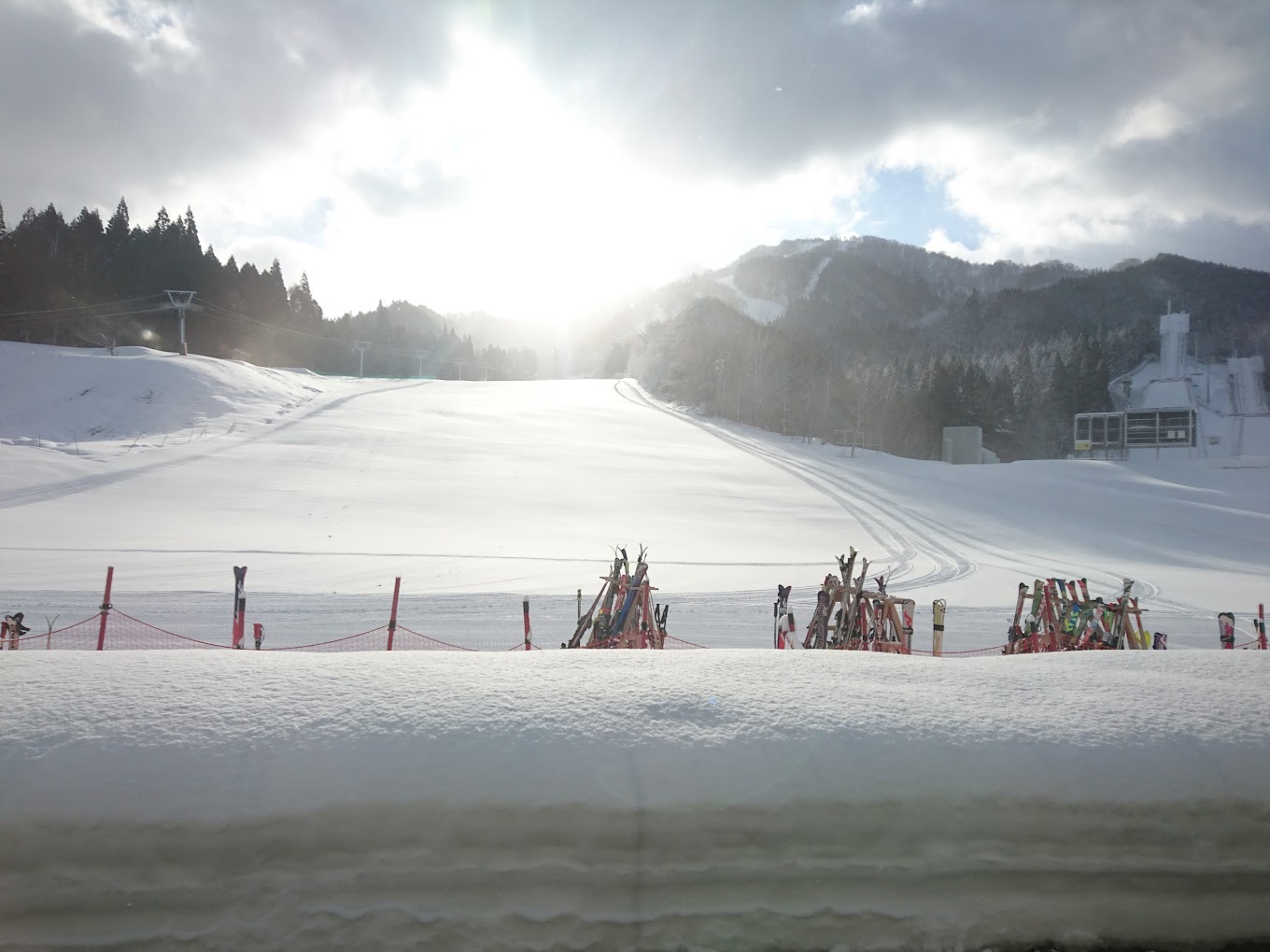 Hanawa in Japan - a group of people standing on top of a snow covered slope.