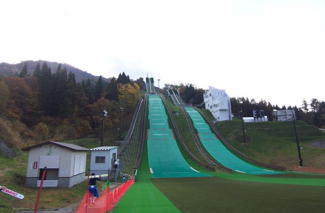 Hanawa in Japan - a ski slope with a green ramp going down it.
