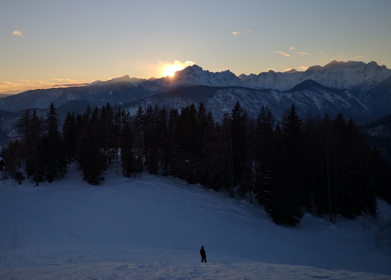 Španov vrh in Slovenia - a person standing on top of a snow covered mountain.