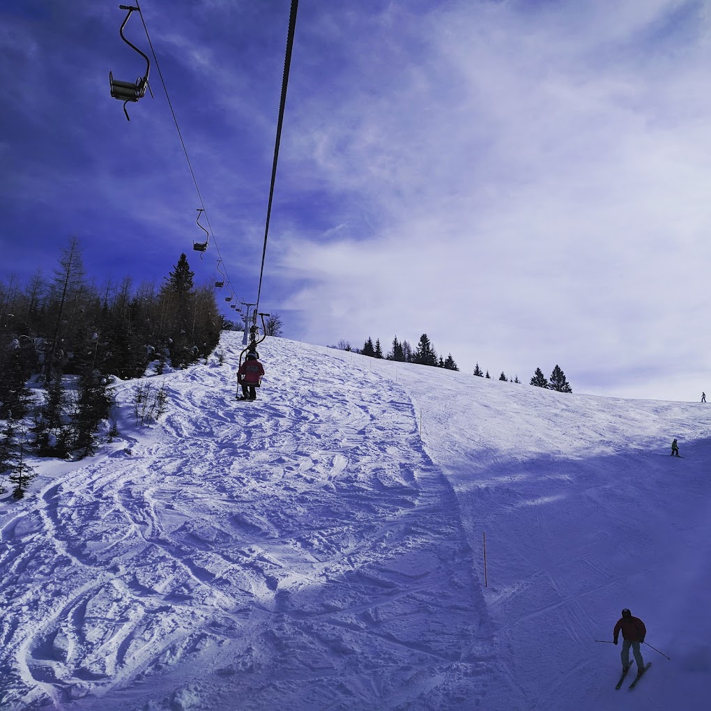 Španov vrh in Slovenia - a person is skiing down a snowy hill.