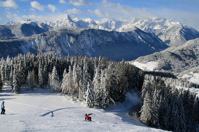 Španov vrh in Slovenia - a group of people skiing down a snowy slope.