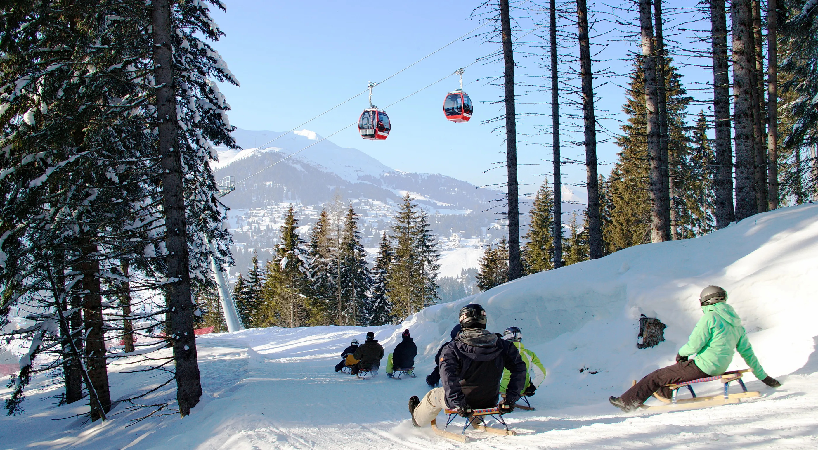 Sciovie Baita Valbella in Italy - a group of people riding down a snow covered slope.
