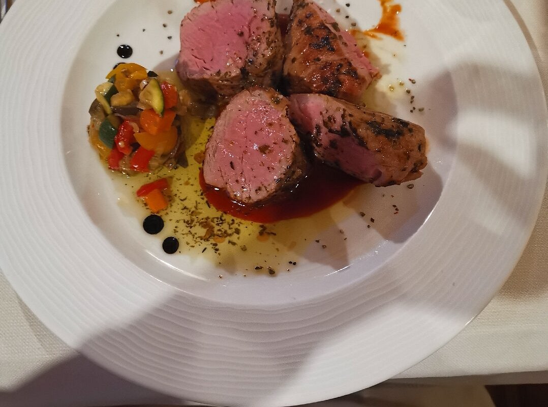 Sciovie Baita Valbella in Italy - a plate with meat and vegetables on it.