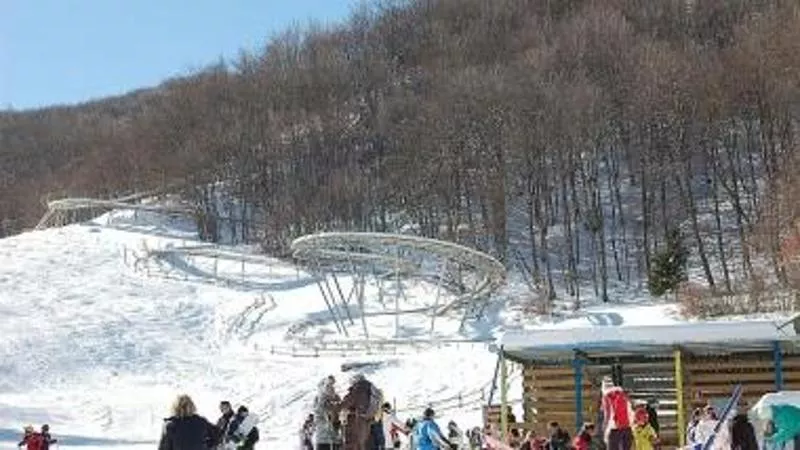Seggiovia di Caldirola in Italy - a group of people skiing down a snowy slope.